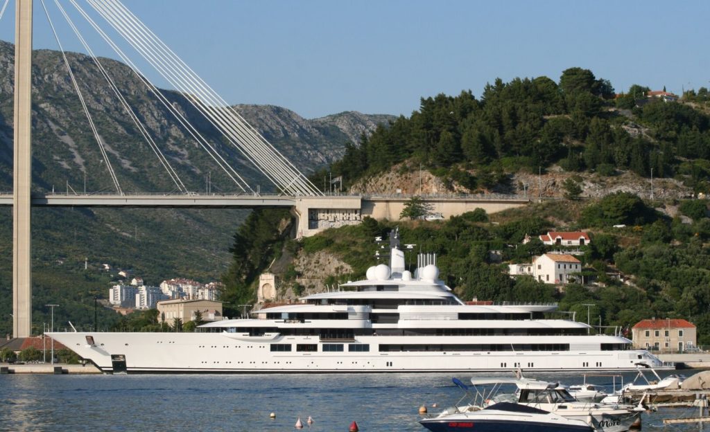 superyacht next to the bridge and smaller yachts